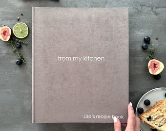 May include: A gray linen-covered recipe book with the text "from my kitchen" and "Lisa's recipe book" printed on the front cover.