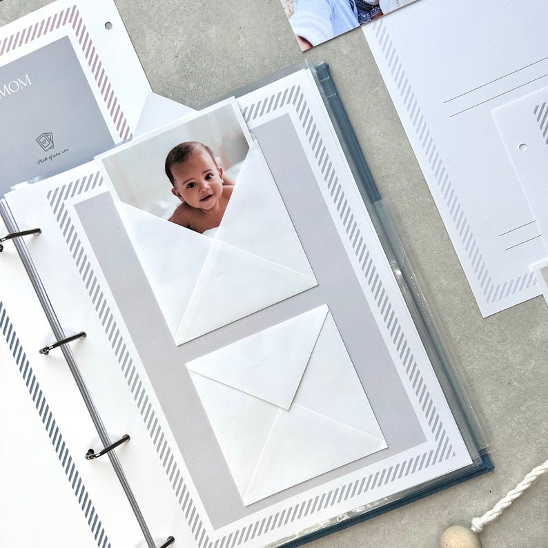 Inside pages of a handmade baby memory book designed to capture milestones and photo memories. Each page features dedicated spaces for firsts like smiles, steps, birthdays, and family moments. With its soft, minimal layout, parents can easily add, remove, or rearrange pages as their baby grows. Thoughtfully designed with photo areas and prompts for notes, this keepsake helps preserve every special moment from birth through the early years in a beautifully organized way.