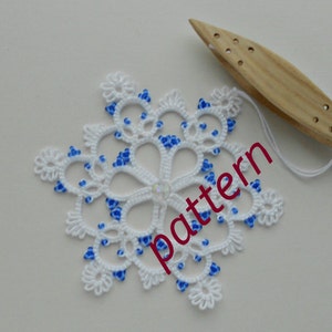 May include: White snowflake lace doily with blue beads, a wooden bobbin lace shuttle, and the word "pattern" in red text.