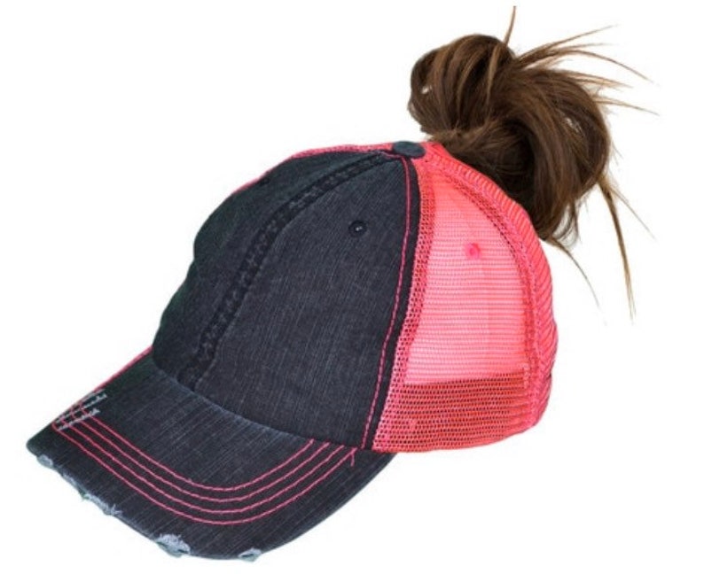May include: A black and pink distressed baseball cap with a mesh back. The cap has a ponytail hole in the back.