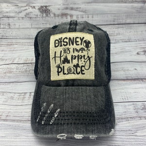 May include: A black distressed baseball cap with a white patch that says "Disney is my happy place" with various Disney icons.