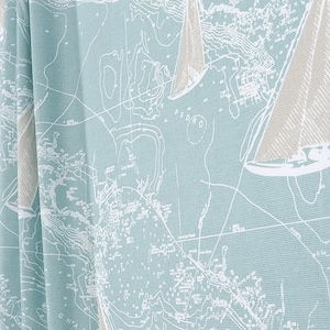 May include: A light blue fabric with a white nautical map pattern featuring sailboats. The fabric has a subtle texture.