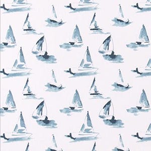 May include: A white fabric with a repeating pattern of blue watercolor sailboats. The sailboats are of varying sizes and are depicted in a simple, abstract style.