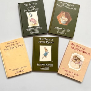 May include: Five vintage Beatrix Potter books are displayed, including "The Tale of Jemima Puddle-Duck" and "The Tale of Peter Rabbit." The covers are in shades of green, beige, and peach, with illustrations of the characters. The publisher is F. Warne & Co.