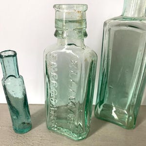 ANTIQUE  &#39;ELLIMAN&#39;S EMBROCATION&#39; Aqua Glass Bottle Collectable Glass Victorian Muscle Rub Glass Bottle Bud Vase  Embossed Glass