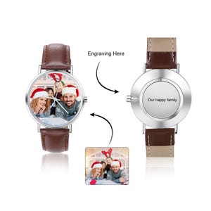 May include: A personalized wristwatch with a brown leather strap. The watch face displays a family photo wearing Santa hats. The back of the watch is engraved with the words "Our happy family". The text "Engraving Here" is also visible.