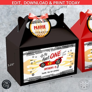 May include: Black gable box with a red race car graphic that reads "Fast One" and "Anthony is 1". The box has a handle and a circular tag with the name "Marie". Dimensions are 5.75 inches wide and 3.25 inches high.