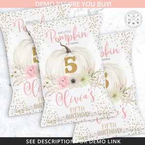 May include: White party favor bags with a pumpkin theme. The bags feature a white pumpkin with a gold glitter number 5, pink floral accents, and the text "Our Little Pumpkin is Turning" and "Olivia's Fifth Birthday". Gold confetti dots the background.