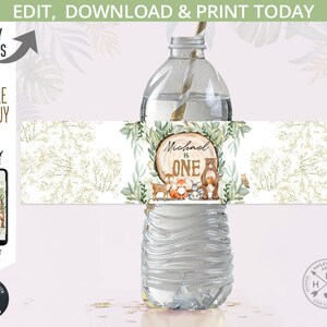May include: Editable water bottle label with a woodland theme. The label features a brown bear, a fox, a deer, and a squirrel. The text on the label reads "Michael is One".