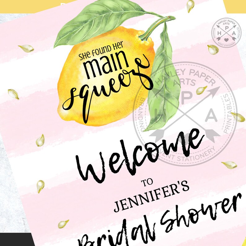 May include: A pink and white striped background with a yellow lemon and green leaves. The text "She found her main squeeze" is written in black cursive. The text "Welcome to Jennifer's Bridal Shower" is written in black cursive.