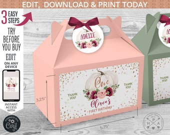 May include: Pink and green favor boxes with a pumpkin and floral design. The boxes are 5.75 inches wide and 3.25 inches tall. The boxes say "One Olivia's First Birthday" and "Thank You!"