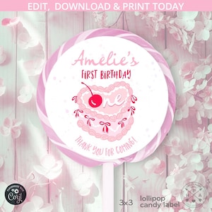 May include: Pink and white lollipop candy label with a pink and white cake with a red cherry on top. The label says "Amelie's First Birthday" and "Thank you for coming!"