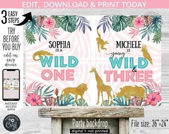 May include: A pink and blue jungle-themed party backdrop with gold glitter accents. The backdrop features a zebra print background with a variety of jungle animals, including a giraffe, lion, rhino, and monkey. The text "Sophia is a Wild One" and "Michele is young Wild & Three" is displayed on the backdrop. The backdrop is 36 inches by 24 inches.