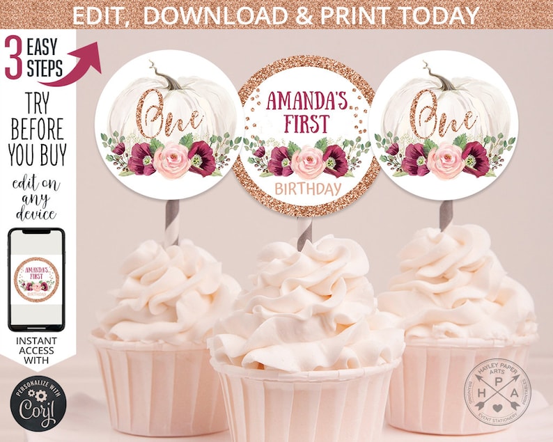 May include: Three cupcake toppers featuring a white pumpkin with a gold glitter background. The toppers have a floral design with pink and burgundy flowers. One topper says "One" in gold glitter, another says "Amanda's First Birthday" in gold glitter, and the third says "One" in gold glitter.