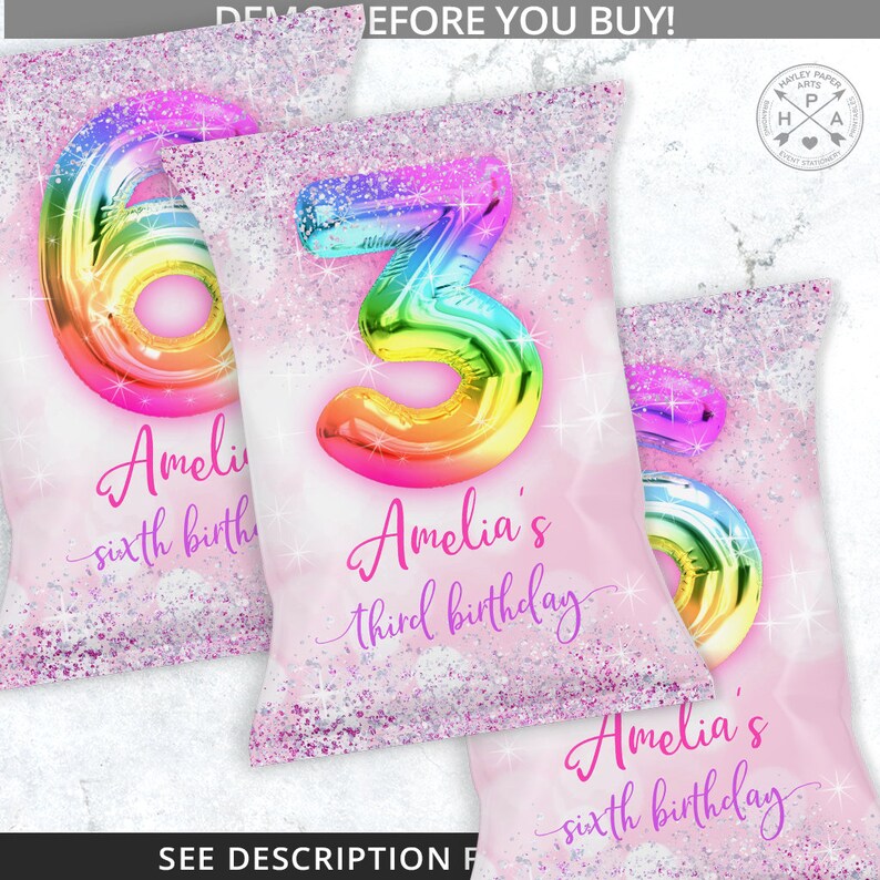 May include: Three pink and white favor bags with a rainbow glitter background. The bags feature a large rainbow balloon number, 3, 6, and 6. The bags are personalized with the name Amelia and the text "third birthday" and "sixth birthday".