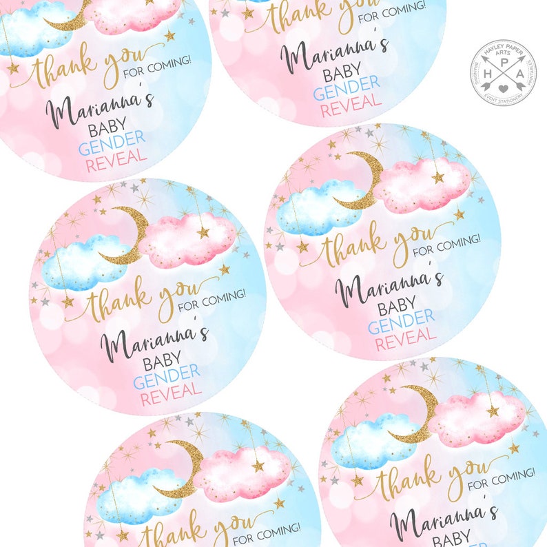 May include: Four round pink and blue gender reveal party favor stickers with gold glitter stars and a crescent moon. The stickers say "Thank you for coming! Marianna's Baby Gender Reveal".