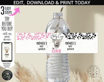 May include: Water bottle label with a pink and black cow print design. The label says "Holy Cow" and "I'm One". It also says "Michele's First Birthday".