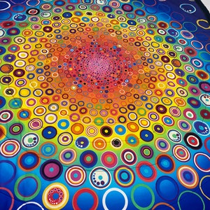 May include: A colorful circular design with concentric circles of various sizes and colors, including blue, green, yellow, orange, red, and purple. The circles are arranged in a spiral pattern, creating a hypnotic effect.