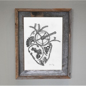 May include: A black and white drawing of a heart made of bicycle parts, including a chain, gears, and a crankset. The drawing is framed in a rustic wooden frame.