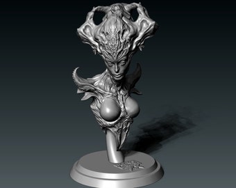 May include: A grayscale sculpture of a female figure with an elaborate headdress and detailed facial features. The bust is mounted on a circular base, showcasing intricate design elements and a stylized aesthetic. The sculpture has a fantasy theme.