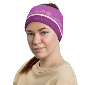 May include: A purple headband with a white and pink floral design. The headband is made of a soft, stretchy material and is perfect for keeping your hair out of your face.