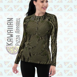 May include: A long-sleeved shirt with a green and brown tree bark pattern. The shirt is made of a stretchy, comfortable fabric and has a crew neck.