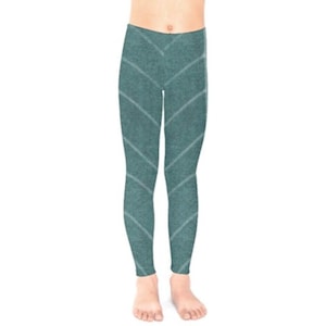 May include: Teal blue leggings with a white geometric pattern. The leggings are made of a soft, stretchy fabric and are perfect for everyday wear.