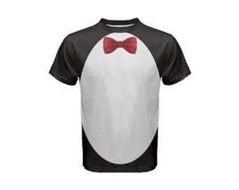 May include: A black and white t-shirt with a red bow tie printed on the front. The shirt has a penguin design with a white oval in the center.