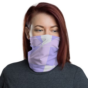 May include: A purple and white geometric patterned face mask. The mask is made of a soft, breathable fabric and is designed to be comfortable to wear.