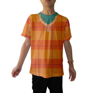 May include: A short-sleeved orange and red plaid shirt with a green undershirt and three silver buttons. The shirt has a v-neck collar.