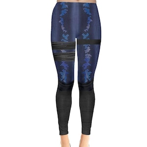 May include: Blue leggings with a black and blue geometric pattern. The leggings have a black band around the thighs.