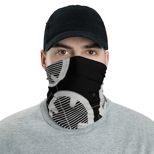 May include: A black and white face mask with a geometric pattern. The mask is made of a soft, breathable fabric and is designed to be comfortable to wear.