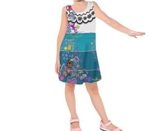 Könnte beinhalten: Ein ärmelloses Kleid mit einem weißen Oberteil mit schwarzem Rüschenbesatz und einem türkisfarbenen Rock. Der Rock hat ein horizontales Streifendesign mit bunten Blumen- und Charaktergrafiken. Das Kleid wird von einer Person getragen.