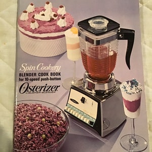 May include: A cookbook titled "Spin Cookery" for the Osterizer 10-speed push-button blender. The cover features a silver blender with a red liquid inside, a bowl of purple shredded cabbage, a glass of purple dessert topped with sprinkles, and a dessert with a purple base and white whipped cream.