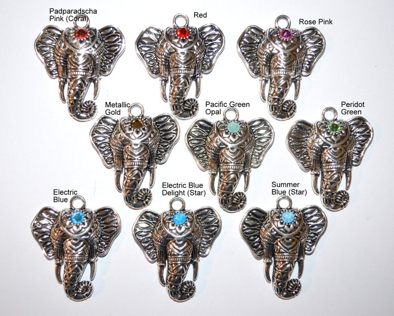May include: A collection of silver-toned elephant charms, each with a different colored gemstone embedded in the forehead. Gemstone colors include red, pink, green, blue, and gold. Text labels identify each color.