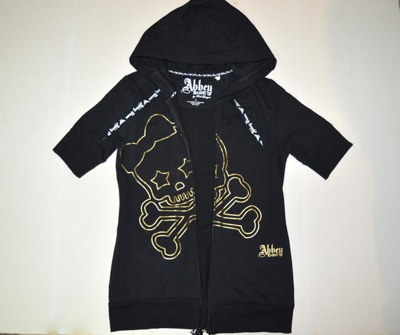 Abbey Dawn スカルデザイン ポンチョパーカー Abbey Dawn Full Zip Gold Skull Black Hoodie - Short Sleeve, Avril