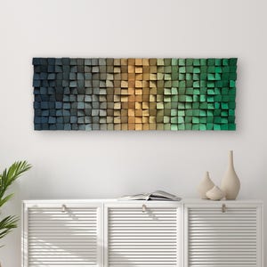 Puede incluir: Una pieza de arte de pared hecha de bloques de madera en tonos de azul, verde y marrón. Los bloques están dispuestos en un patrón de degradado, creando un diseño moderno y abstracto.