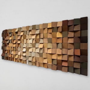 May include: A wall art piece made of wood with a gradient of colours from light to dark. The wood is arranged in a grid pattern with each piece slightly angled. The colours range from light beige to dark brown.