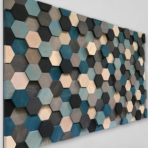 May include: A wall art piece made of wooden hexagonal tiles in shades of blue, grey, and beige. The tiles are arranged in a staggered pattern, creating a textured and modern look.