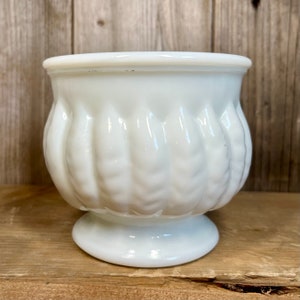 May include: White milk glass planter with a fluted design and a pedestal base.