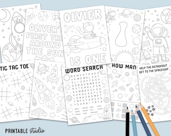 May include: A collection of black and white printable activity sheets with space-themed illustrations. Includes coloring pages, a word search, a tic-tac-toe game, and a maze. The text includes "OLIVER'S FIRST TRIP AROUND THE SUN" and "OLIVIER IS ONE".