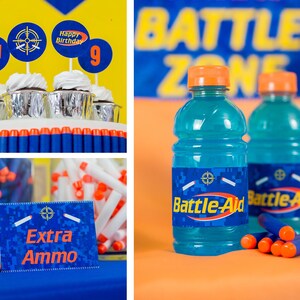 May include: A birthday party setup with blue and orange decorations. There are cupcakes with blue and orange frosting and a sign that says "Happy Birthday". There are also blue and orange drinks with a label that says "Battle-Aid".