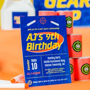 May include: A blue and orange birthday party invitation for AJ's 9th birthday. The invitation includes the date, time, and location of the party, which is a Nerf party with dueling darts. The invitation also includes a phone number to RSVP.