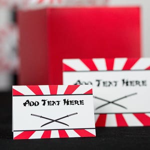 May include: Two white and red striped cards with black swords and the text "Add Text Here".