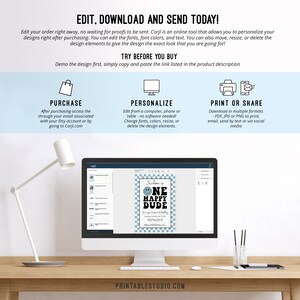 May include: A computer screen displaying a blue and white printable birthday sign with the text "Judson is One Happy Dude". The sign features a smiling face with a blue and white checkered background. The screen is on a wooden desk with a lamp.