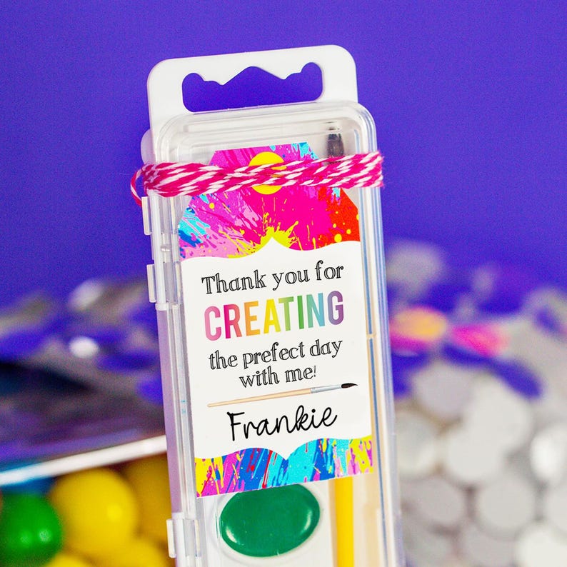 May include: A small clear plastic container with a handle, filled with art supplies. A colorful tag attached to the container reads "Thank you for CREATING the prefect day with me! Frankie".