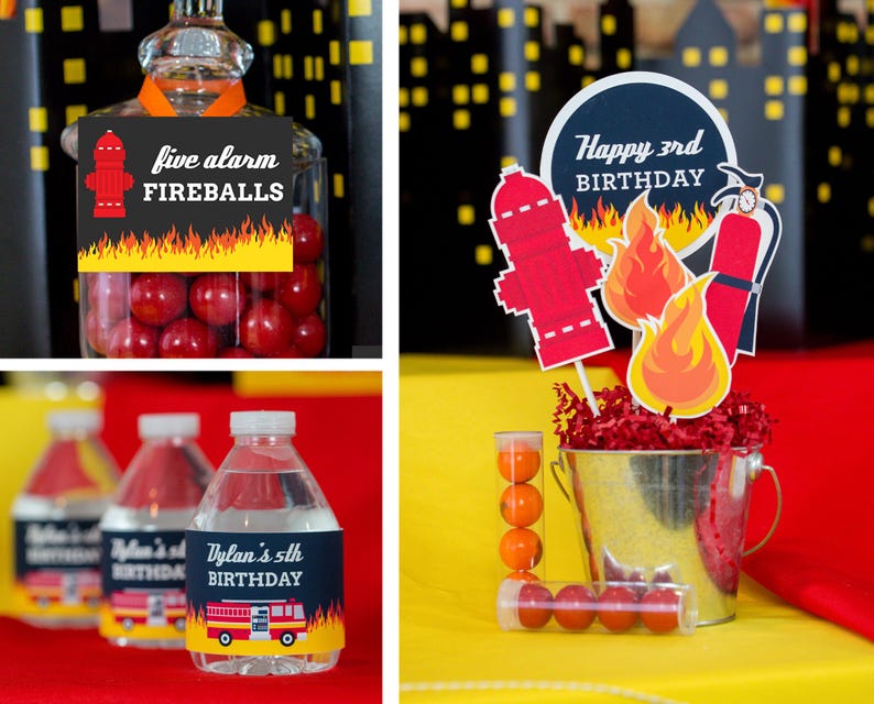 May include: Firefighter themed birthday party decorations with red and yellow fire truck and fire hydrant designs. The decorations include a cake topper with the text "Happy 3rd Birthday", a jar of candy with the text "Five Alarm Fireballs", and water bottles with personalized labels.
