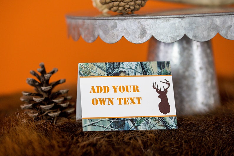 May include: A white card with a camouflage pattern border and a deer silhouette. The card has the text "ADD YOUR OWN TEXT" in orange.