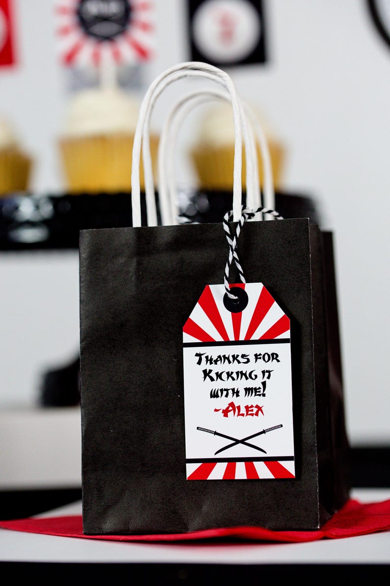 May include: Black and white favor bag with a red and white tag that says "Thanks for kicking it with me! -Alex".