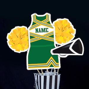 May include: Green and gold cheerleader outfit with a white name tag that says "NAME" on it. The outfit is surrounded by yellow pom-poms and a black megaphone.